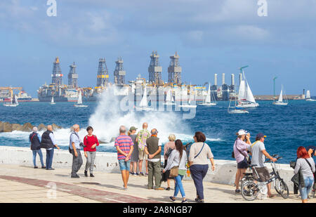 Las Palmas, Gran Canaria, Canary Islands, Spain. 10th November, 2019.  Yachts sail past drilling ships as they head out to the start line of the world`s largest transocean sailing event, the ARC Transatlantic.  Yachts leave Las Palmas in two groups, one on Sunday 10th November with the second (larger) group leaving on 21st November. The race/rally starts in Las Palmas and finishes in Rodney Bay on St. Lucia in The Caribbean. Crews from more than 40 countries, including many from Great Britain, will be on board approximately 300 yachts making the crossing. Credit: Alan Dawson /Alamy Live News Stock Photo
